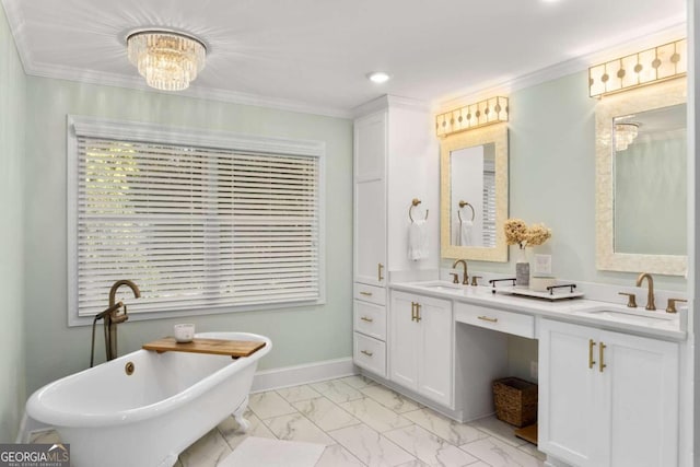 bathroom with ornamental molding, vanity, an inviting chandelier, and a bathing tub