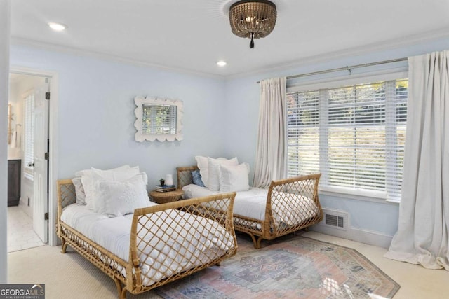 sitting room with carpet flooring and crown molding