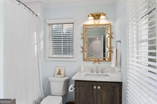 bathroom with vanity, toilet, and crown molding