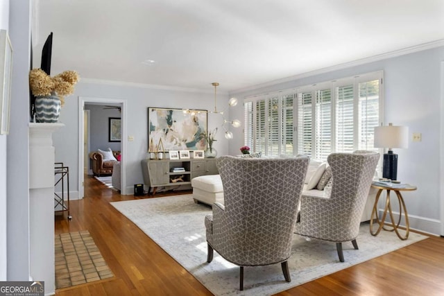 living room with hardwood / wood-style flooring and ornamental molding