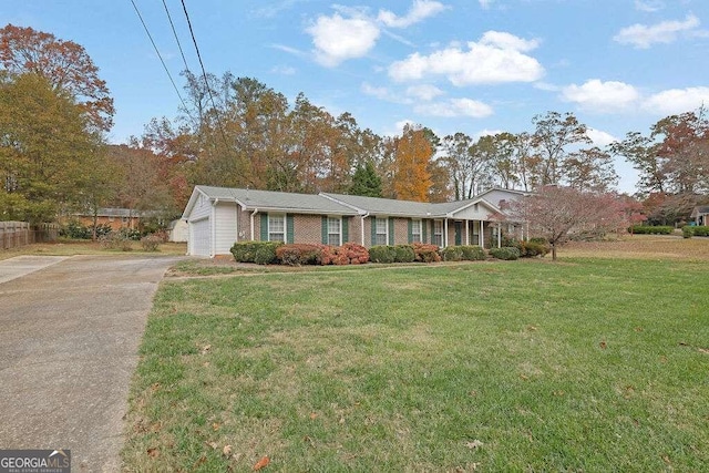 ranch-style house featuring a front yard and a garage