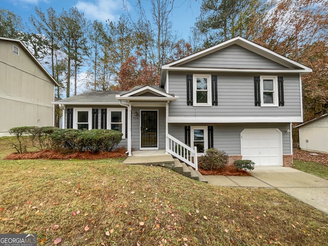 split level home with a front yard and a garage