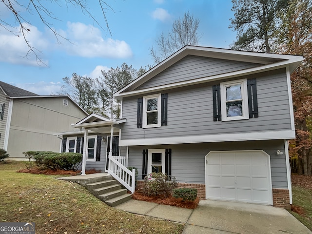 split level home featuring a garage and a front yard