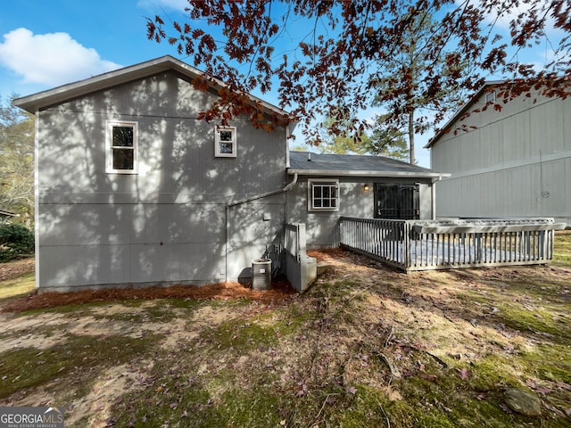 back of property featuring cooling unit and a deck