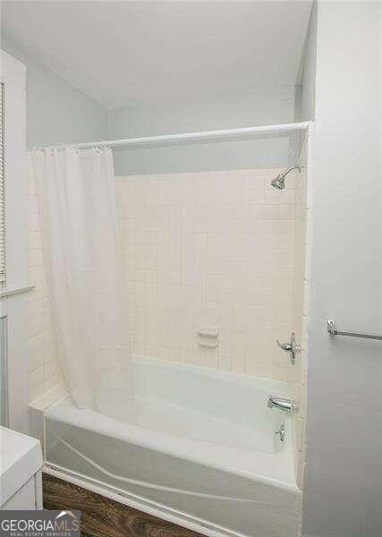 bathroom featuring vanity and shower / tub combo with curtain