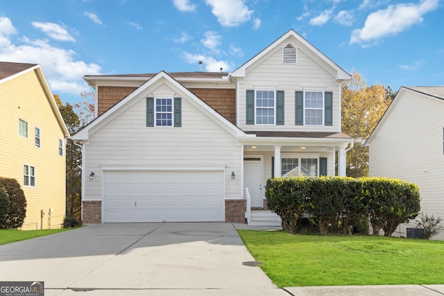 view of property featuring a front yard and a garage