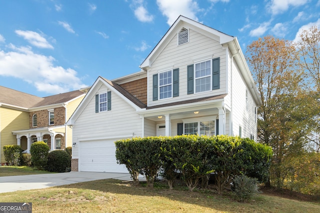 view of front of house with a garage and a front lawn