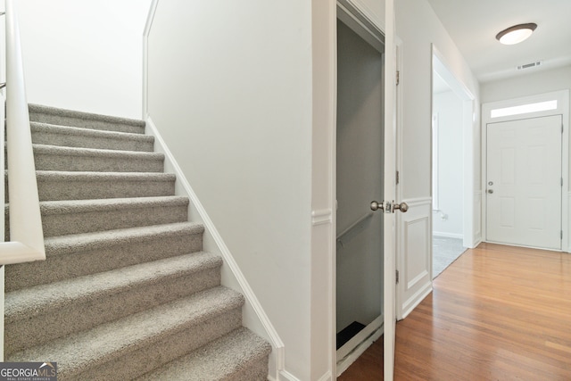 stairs featuring hardwood / wood-style flooring