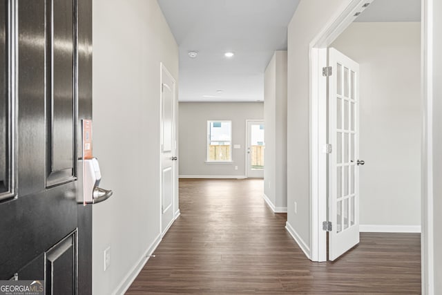 corridor featuring dark hardwood / wood-style flooring