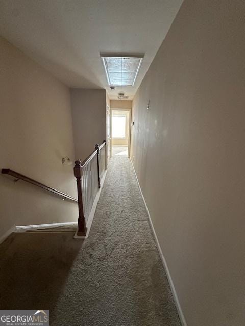 hallway with dark colored carpet