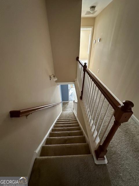 stairs featuring carpet floors