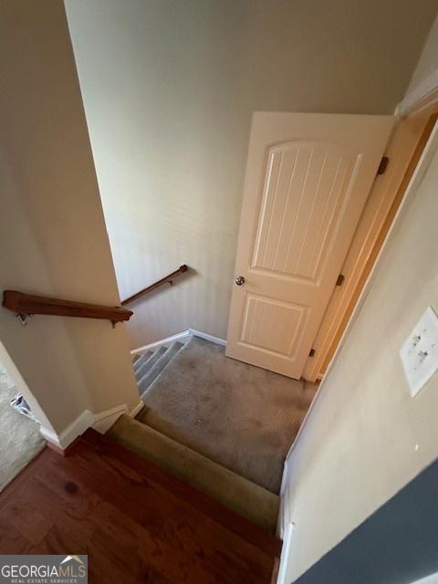 staircase with hardwood / wood-style flooring