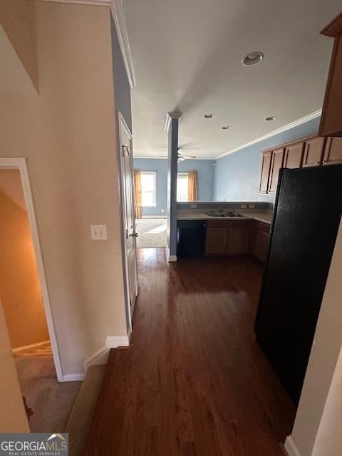 kitchen with sink, ornamental molding, black appliances, and kitchen peninsula