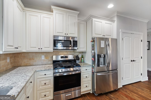 kitchen featuring crown molding, white cabinetry, dark wood-type flooring, and appliances with stainless steel finishes