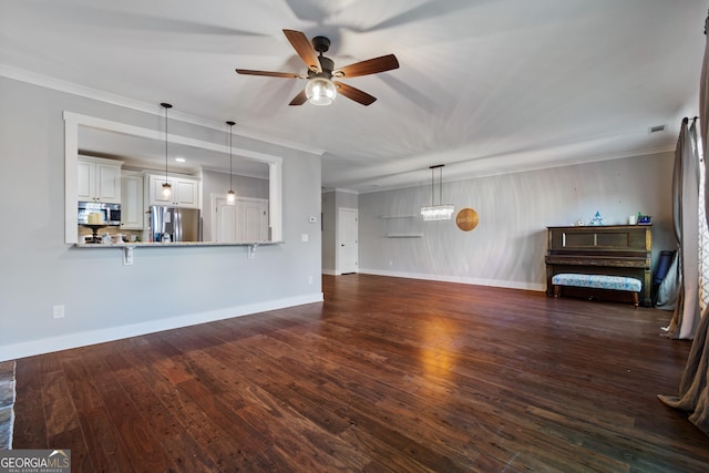 unfurnished living room with dark hardwood / wood-style flooring, ceiling fan, and ornamental molding