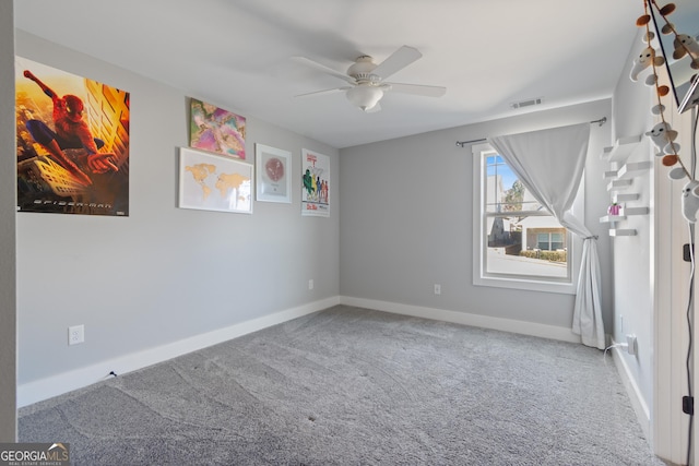 empty room with carpet floors and ceiling fan