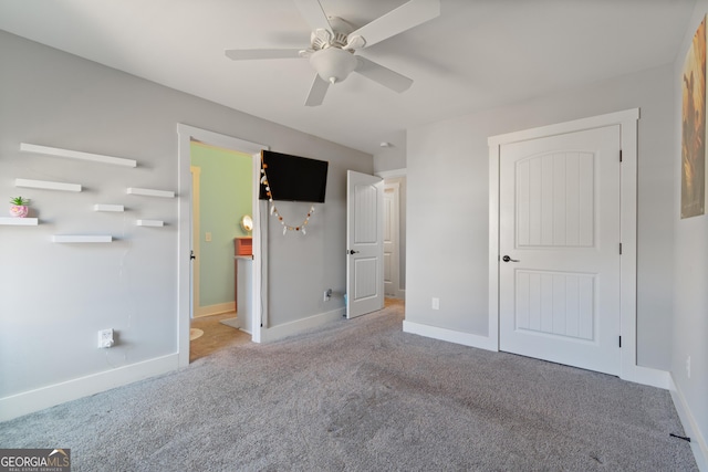 unfurnished bedroom featuring ceiling fan and light carpet