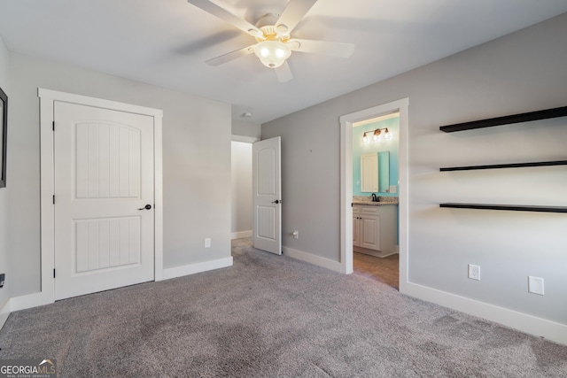 unfurnished bedroom featuring ensuite bathroom, ceiling fan, and light colored carpet