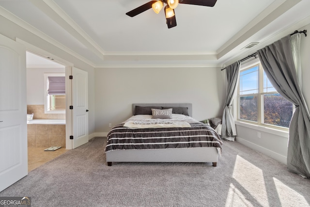 carpeted bedroom featuring ceiling fan, crown molding, and a tray ceiling