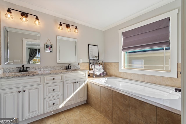 bathroom featuring tile patterned flooring, vanity, crown molding, and tiled tub