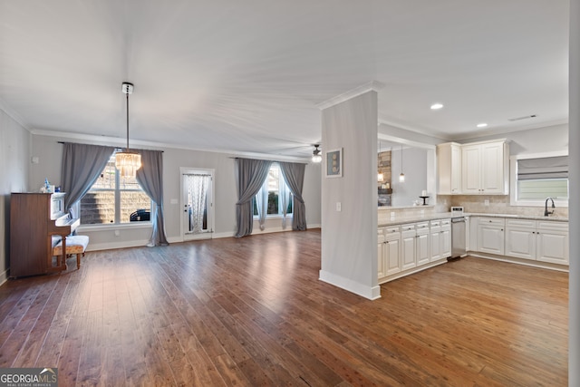 kitchen featuring ceiling fan, sink, crown molding, wood-type flooring, and white cabinets