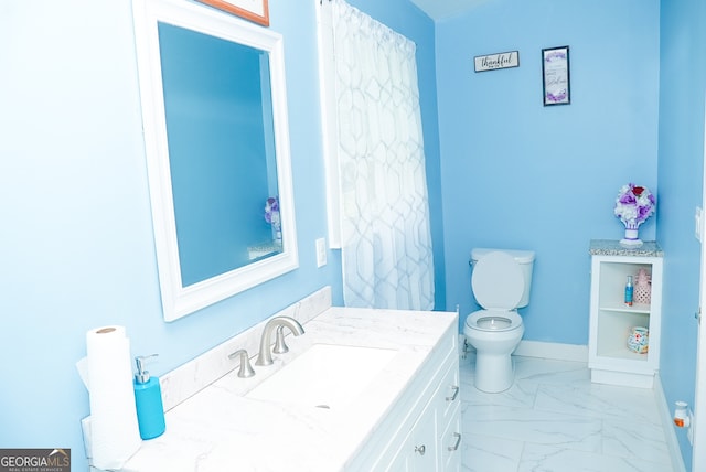 bathroom featuring vanity and toilet