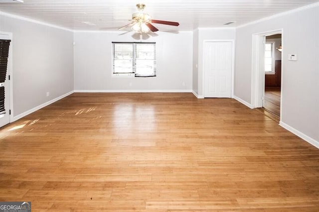 unfurnished room with a fireplace, light hardwood / wood-style flooring, ceiling fan, and ornamental molding