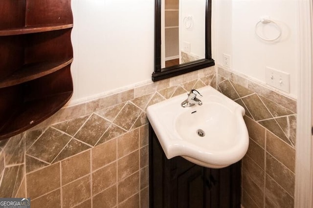 bathroom with vanity and tile walls