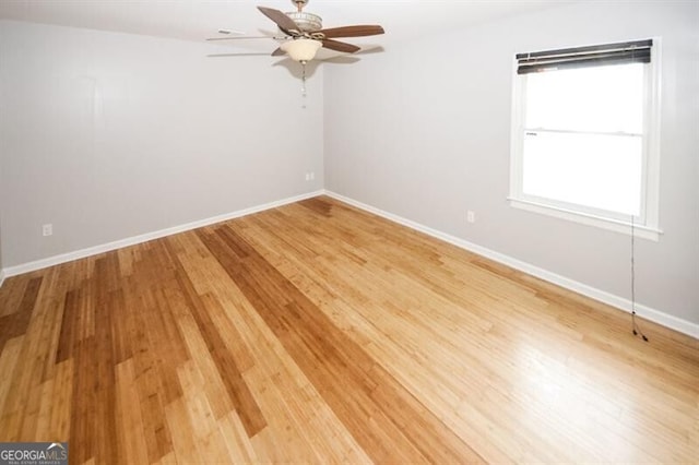 empty room featuring ceiling fan and hardwood / wood-style flooring