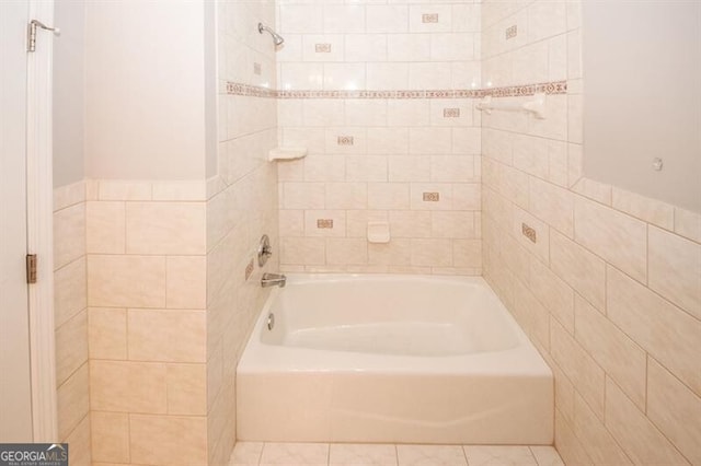 bathroom with tile patterned floors and tiled shower / bath combo