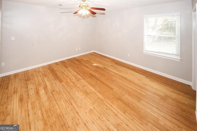 spare room with ceiling fan and light wood-type flooring