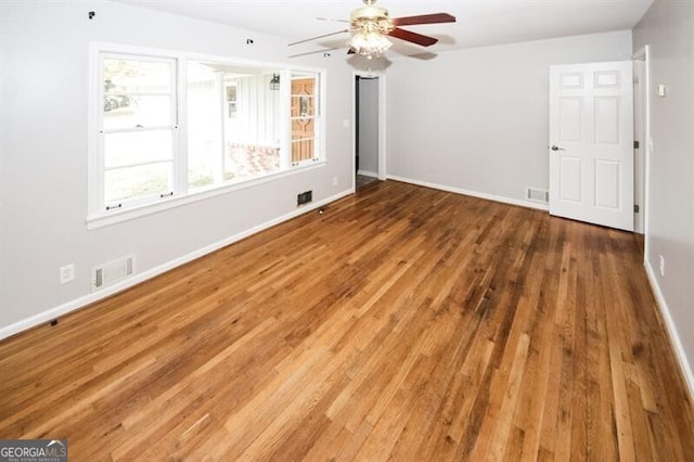 spare room featuring hardwood / wood-style floors and ceiling fan