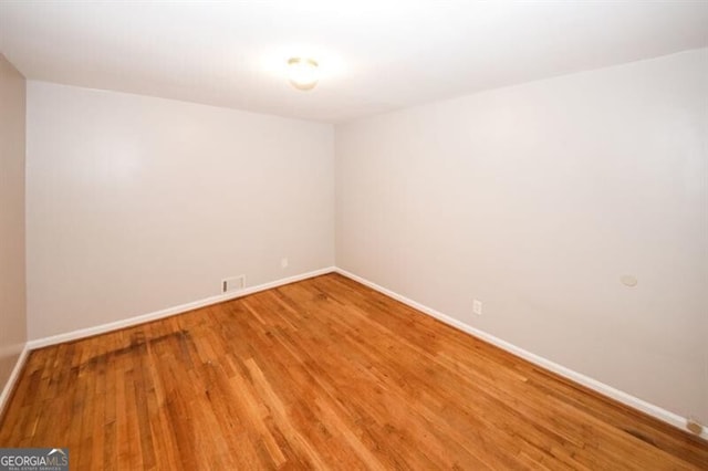 unfurnished room featuring hardwood / wood-style floors