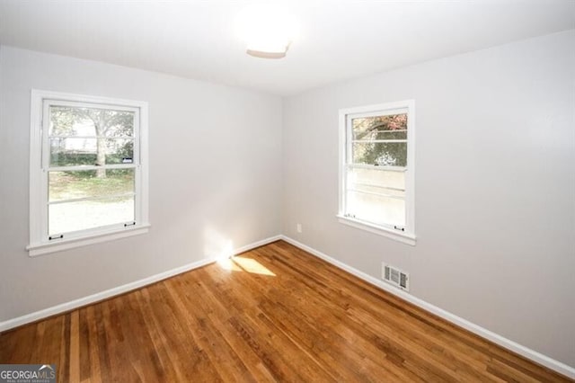 spare room with hardwood / wood-style flooring