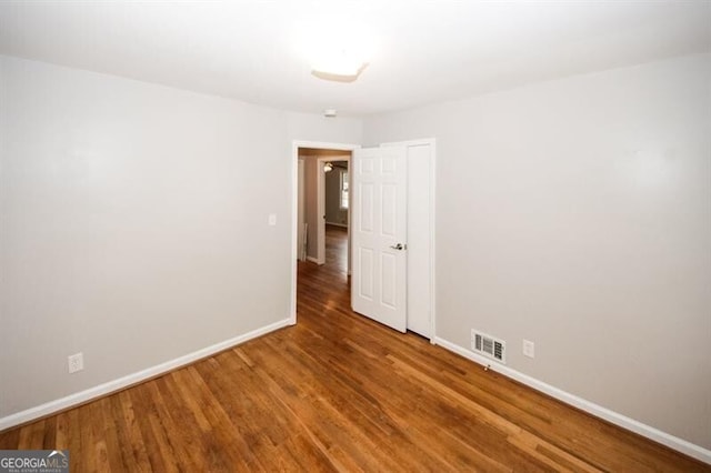 spare room with wood-type flooring