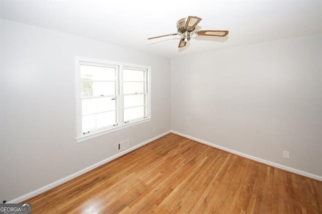 unfurnished room featuring ceiling fan and light wood-type flooring