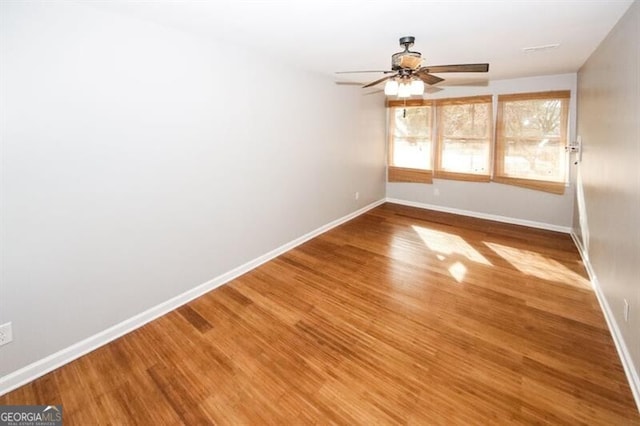 empty room featuring hardwood / wood-style flooring and ceiling fan