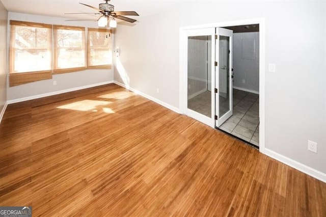 empty room featuring ceiling fan and hardwood / wood-style flooring