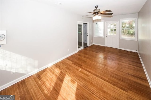 interior space with wood-type flooring and ceiling fan