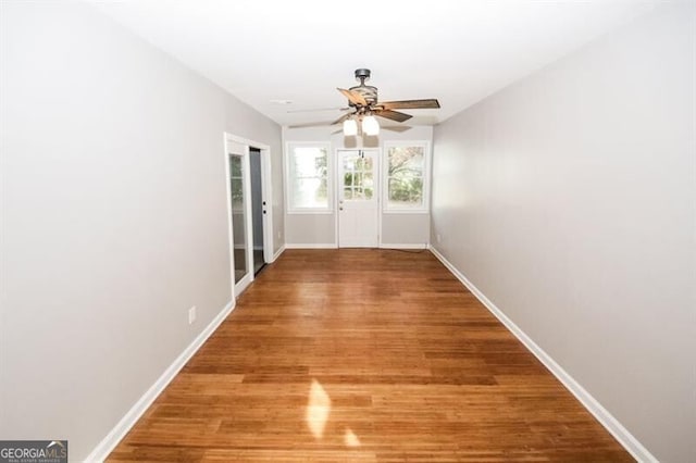 doorway featuring hardwood / wood-style flooring and ceiling fan