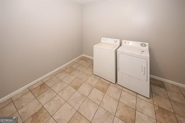 clothes washing area featuring separate washer and dryer and light tile patterned floors