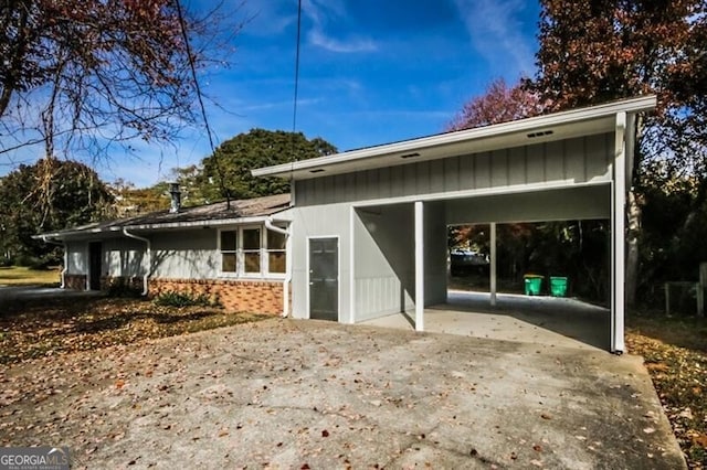 back of house featuring a carport