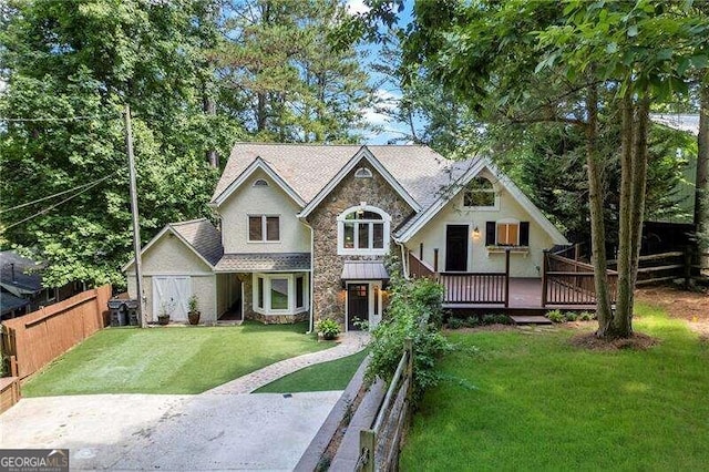 view of front of house featuring a deck and a front lawn