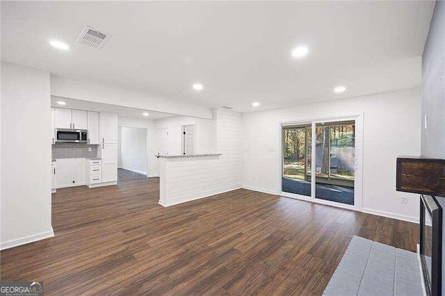 unfurnished living room with dark hardwood / wood-style floors