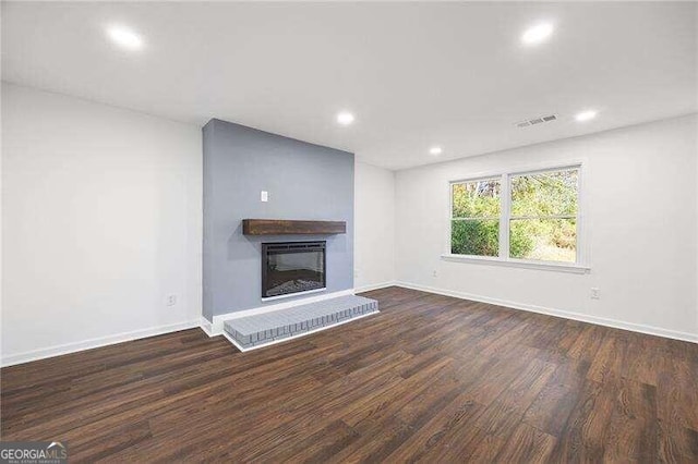 unfurnished living room with dark wood-type flooring