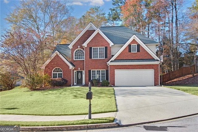 view of front of property featuring a front yard and a garage