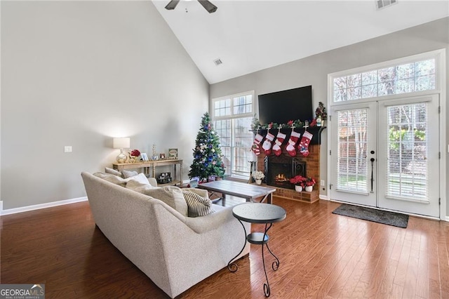 living room with hardwood / wood-style floors, french doors, high vaulted ceiling, and ceiling fan