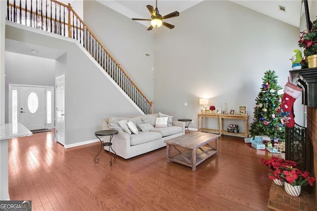 living room featuring hardwood / wood-style floors, high vaulted ceiling, and ceiling fan