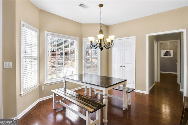 dining room featuring a chandelier and dark hardwood / wood-style floors