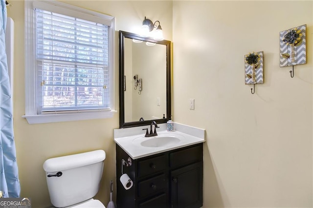 bathroom featuring vanity and toilet